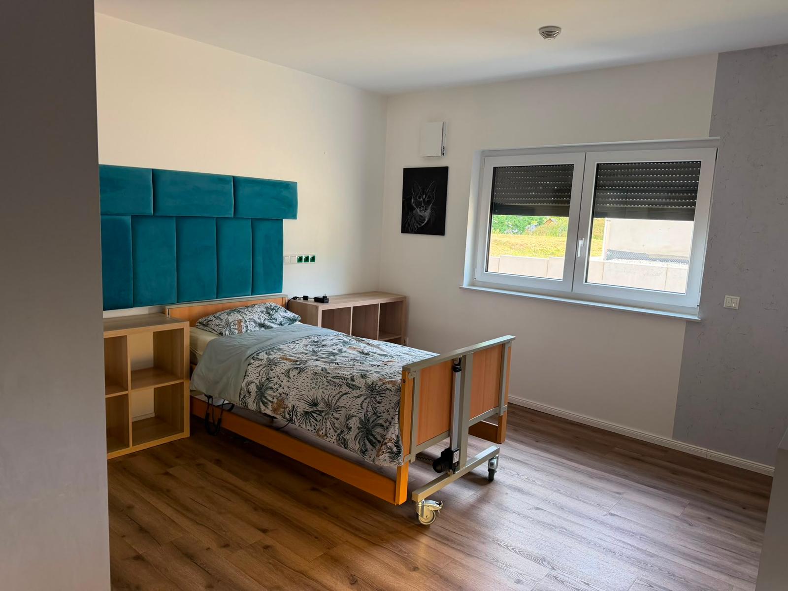Zimmer mit Pflegebett und Blick ins Grüne